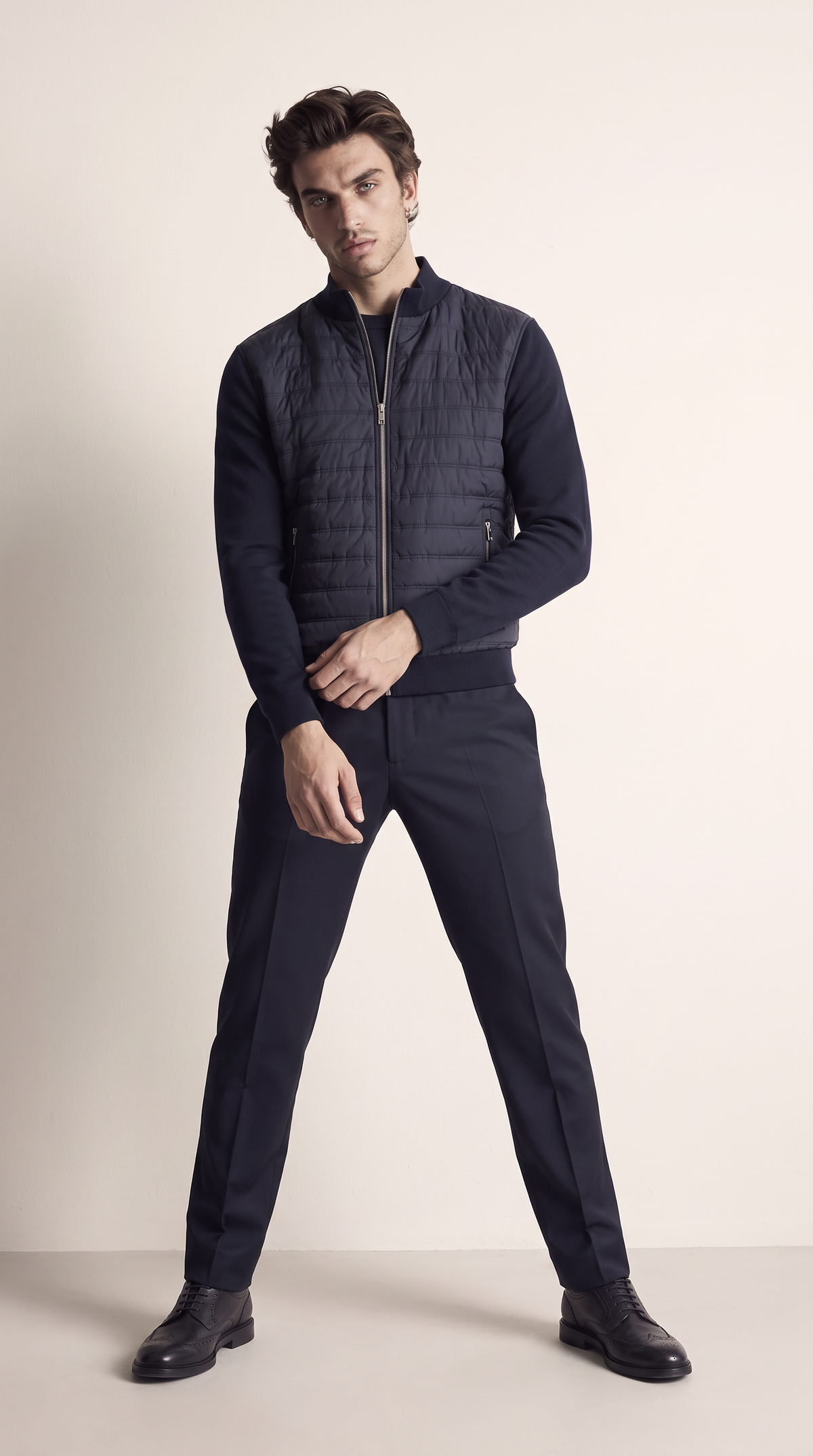 Men's navy hybrid quilted zip-up jacket, front view
